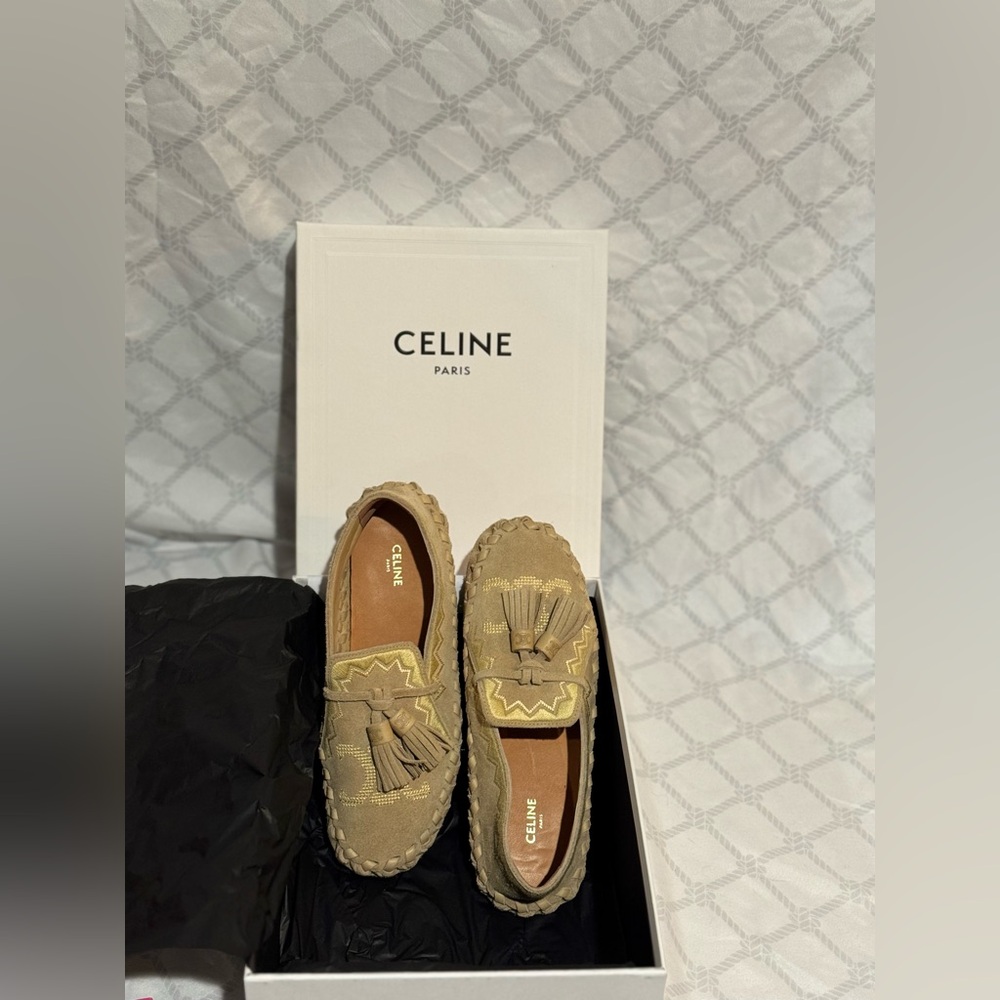 Celine Marlou flat slip-on shoes with Triomphe embroidery and tassels.